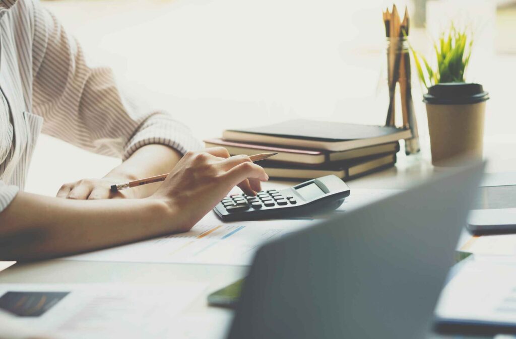 Business owner reviewing financial documents after breaking a loan covenant