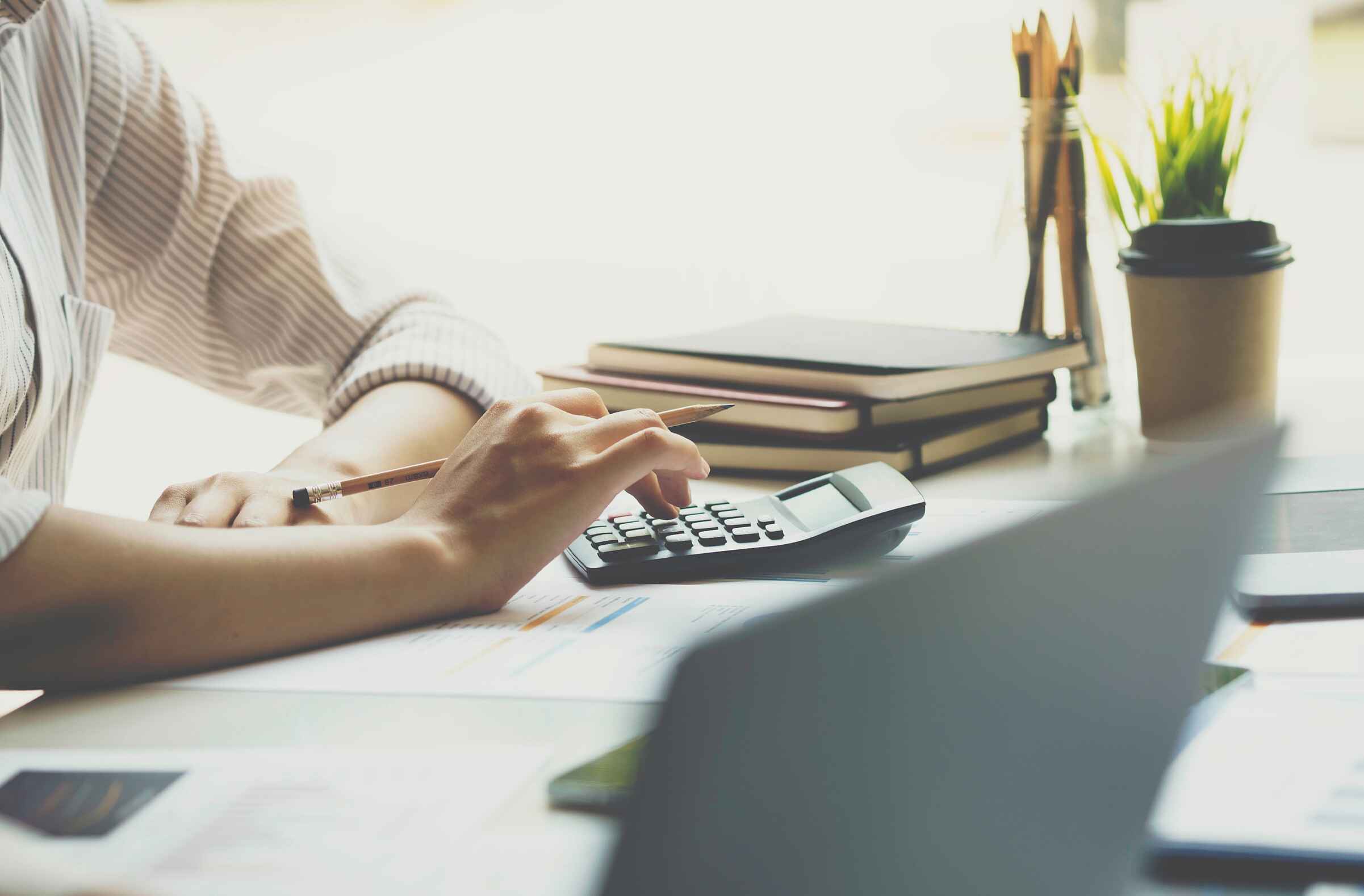 Business owner reviewing financial documents after breaking a loan covenant