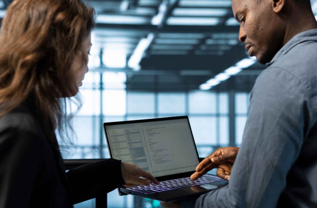 Business owners reviewing business financing options on a laptop